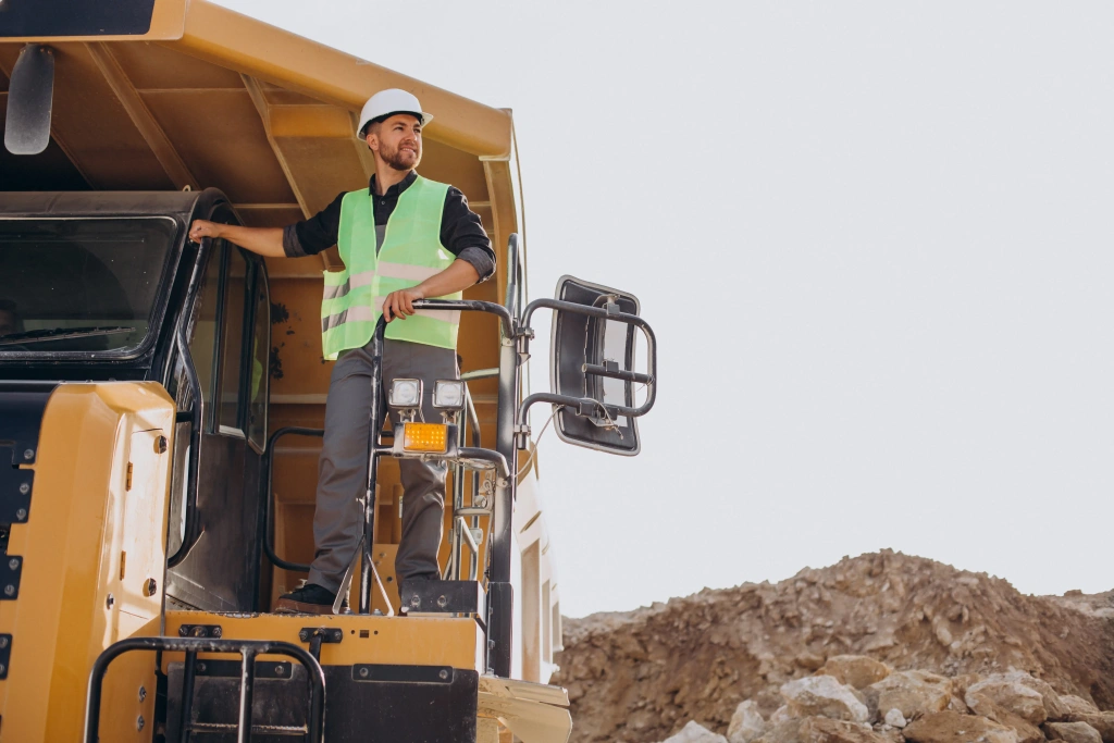 male-worker-with-bulldozer-sand-quarry.webp